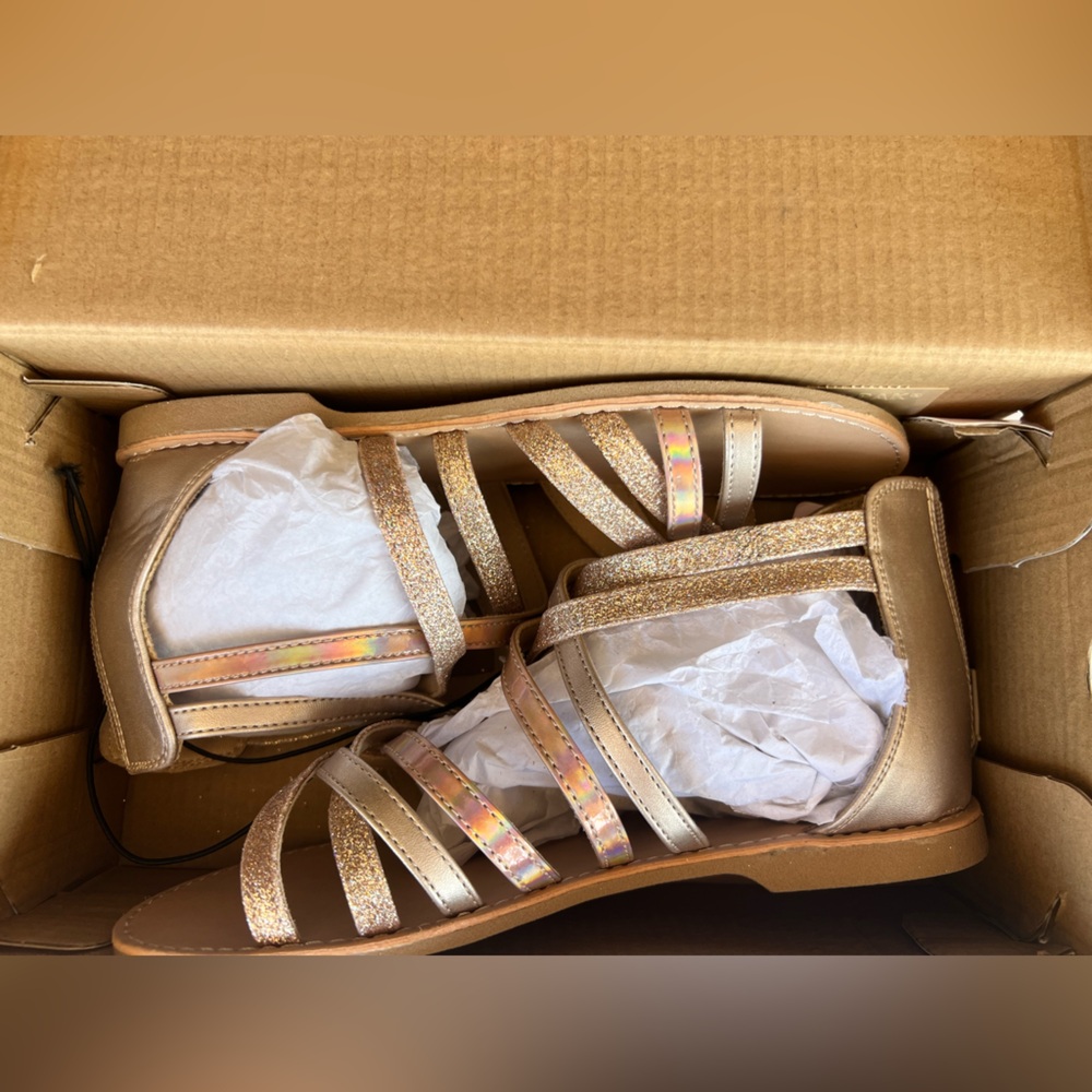 Strappy rose gold sandles. Previously owned but never worn.